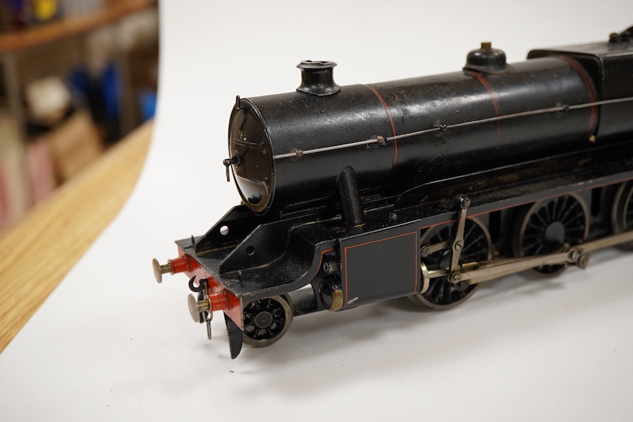An 0 gauge Bassett-Lowke live steam spirit fired tinplate BR 2-6-0 Mogul tender locomotive, 42980, with original fuel tank and burner, two controls in the cab accessed through the cab roof